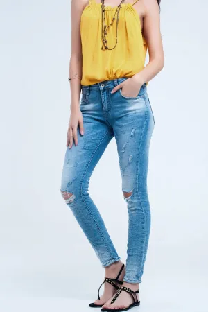 Skinny jeans in mid wash with knee rips